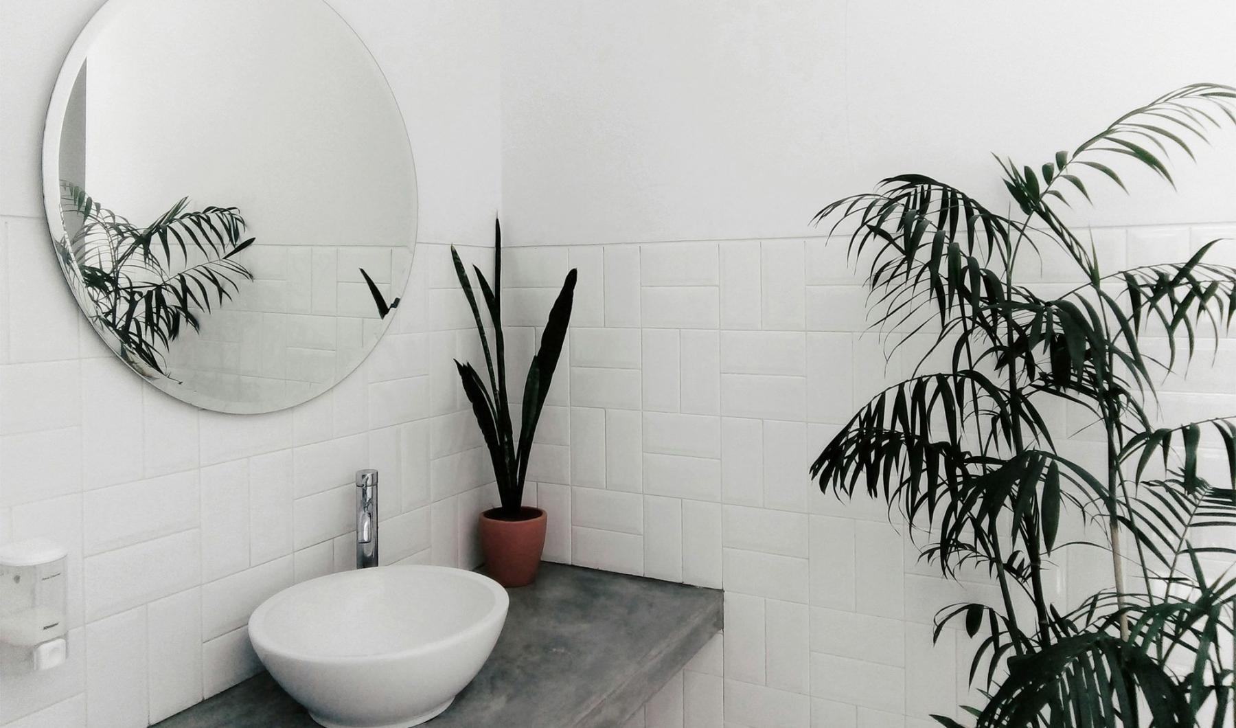 a bathroom with a round mirror